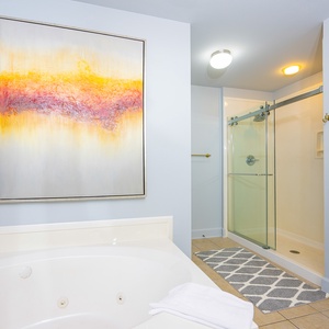 Indulge in relaxation in the master bath with a refreshing walk-in shower and soothing jetted tub