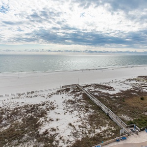 Gaze at the expansive shoreline and gentle waves, perfect for a relaxing beach getaway