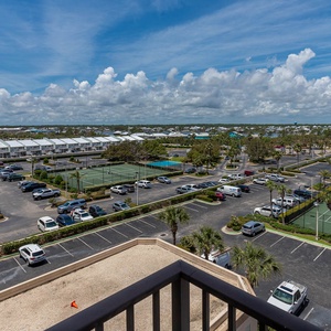 Enjoy views of lush greenery and tennis courts from the master balcony, perfect for relaxation
