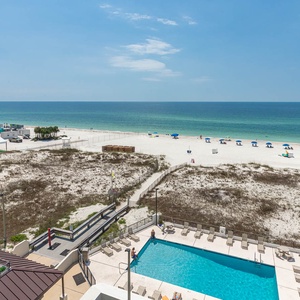 Experience breathtaking beachfront views from this inviting poolside area, perfect for relaxation and sunbathing
