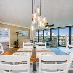 Savor morning coffee at the inviting dining table while basking in the light-filled ambiance of this serene space