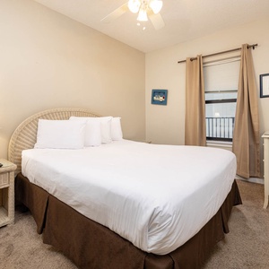 Comfortable guest bedroom featuring a queen bed, a TV, and charming coastal decor for a restful stay