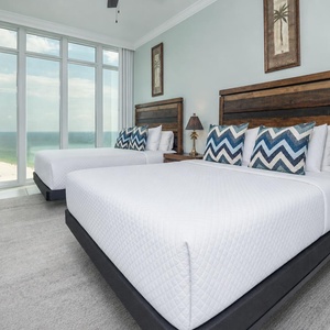 Wake to a breathtaking sunrise in this queen guest suite with two cozy beds and expansive views from the windows