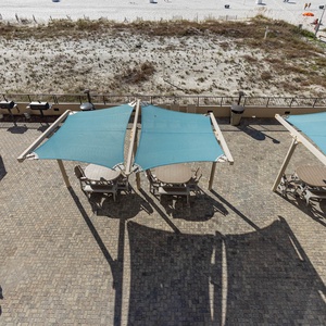 Gather around the shaded tables at the outdoor pool area, perfect for enjoying meals and relaxing in the warm sunshine
