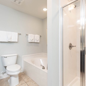 Enjoy a relaxing soak in the spacious jetted tub or refreshing walk-in shower in this inviting master bathroom