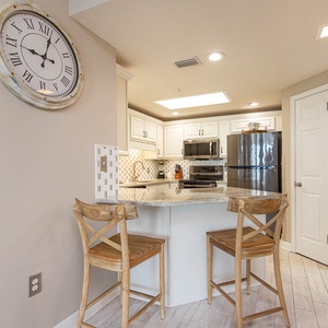 Enjoy casual meals at the stylish breakfast bar, surrounded by the modern kitchen and charming decor