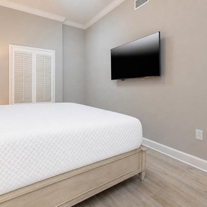 Relax on the cozy king bed in this guest suite and stream your favorite shows after a beach day