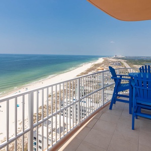 Imagine sipping a cool drink at the blue table while gulf waves and the shoreline stretch below