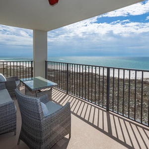 Balcony seating offers a serene view of the gulf and beach, perfect for relaxation and enjoying the coastal atmosphere