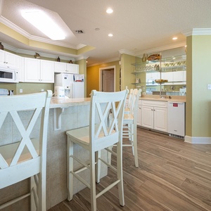 Gather for fun conversations at the breakfast bar, surrounded by cheerful decor and a warm vibe