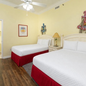Rest in this cheerful guest bedroom featuring two double beds, coastal decor, and a convenient layout