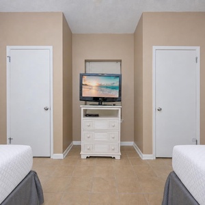 Guest suite with two double beds lets you unwind while streaming your favorite beachside shows on TV