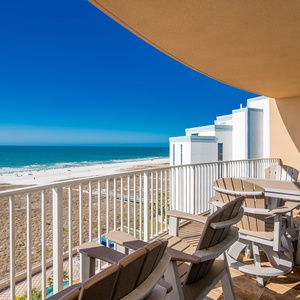Savor the coastal breeze as you gather on the spacious balcony, taking in the stunning beachfront view