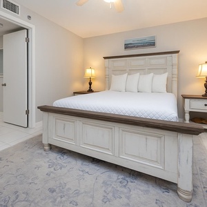 Guest bedroom featuring a queen bed with plush white linens, a stylish nightstand, and soft lighting for relaxation