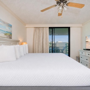Unwind after a fun vacation day and stream your favorite shows in the king master suite with balcony access