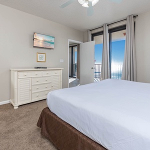 Retreat to the master suite with a plush king bed, a TV for entertainment, and beachfront balcony access