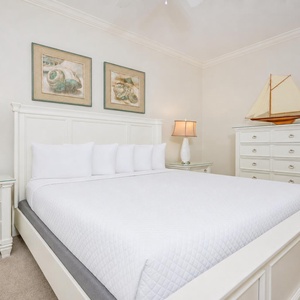 Bright and airy guest bedroom featuring a plush king bed, stylish decor, and soft lighting for a cozy retreat