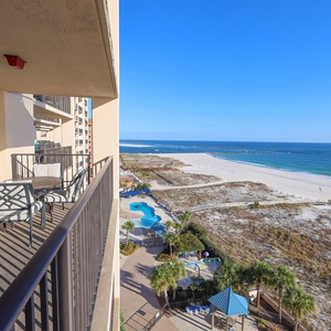 Relax on the balcony and take in views of the pool and the inviting shoreline beyond