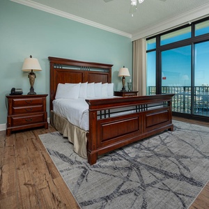 Retreat to the king master suite with cozy bedding and drift off to the sound of the waves from the balcony