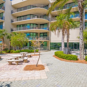 Gather with friends around the stone tables in the outdoor picnic area, enjoying the fresh air and coastal vibe