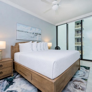 Serene guest bedroom featuring a king bed, stylish decor, and large windows that invite natural light