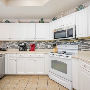 Whip up delicious meals at the inviting kitchen, surrounded by coastal decor and ample countertop space