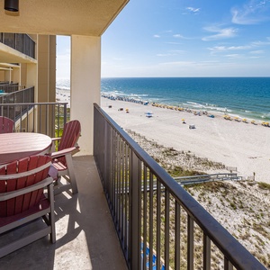 Expansive beachfront view showcasing soft white sand and vibrant umbrellas, inviting relaxation and enjoyment by the water