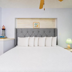 Cozy king suite lets you unwind with fluffy pillows or on the patio after a day exploring the coast