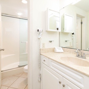 Refresh in this master bathroom featuring a spacious vanity, modern fixtures, and a glass-enclosed walk-in shower