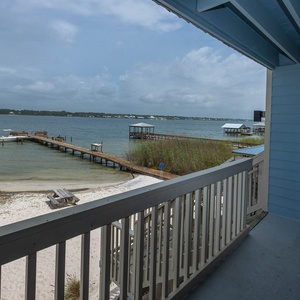 Enjoy a serene lagoon view from the balcony, complete with colorful kayaks and a peaceful sandy shoreline