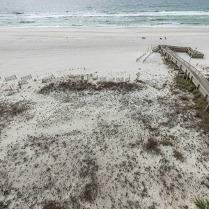 Step onto the boardwalk path leading to the beach, perfect for leisurely strolls and enjoying the coastal breeze