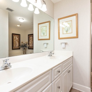 Refresh in the master bathroom featuring dual sinks, elegant decor, and a walk-in shower for your comfort