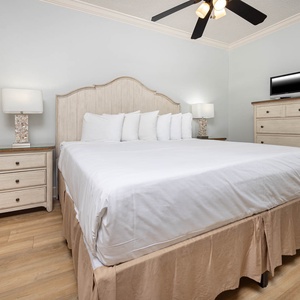 Unwind in the tranquil geust bedroom featuring a plush queen bed, stylish decor, and convenient storage for your belongings