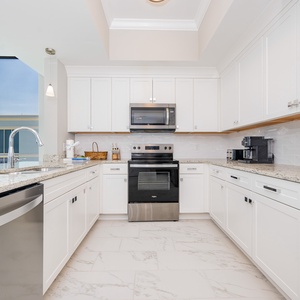 Prepare meals in the stylish kitchen, featuring sleek countertops, stainless appliances, and modern cabinetry