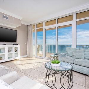 Relax in the soft couch, enjoying warm sunlight and stunning views of the coast through expansive glass doors