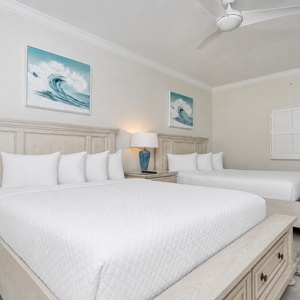Coastal guest bedroom with featuring two queens with soft linens and fluffy pillows