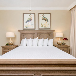 Drift into relaxation on the king bed in the master, surrounded by serene decor for the perfect beach retreat