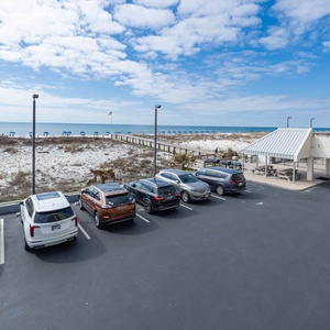 This view showcases a beautiful beachfront area with umbrellas, inviting guests to relax and enjoy the serene atmosphere