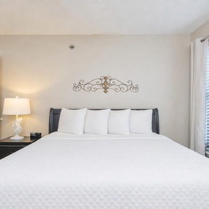Unwind after a day at the beach in the queen guest suite with fluffy pillows and soft bedding