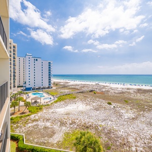 Breathe in the fresh coastal air from your balcony while enjoying views of the beach and shimmering waters below