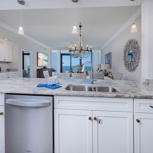 Prepare meals while enjoying stunning beach views from this inviting kitchen and elegant dining space