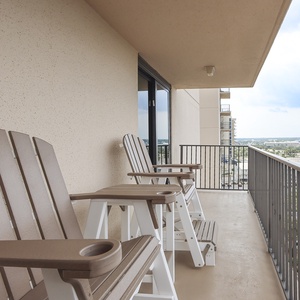 Relax on the master balcony in comfortable chairs, enjoying fresh air and views of the surrounding area