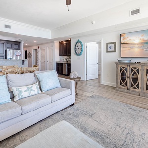 Relax in your coastal-inspired living space, where ocean blues meet elegant comfort and beach artwork sets the perfect vacation mood.