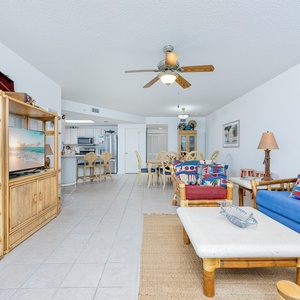 Relax in the inviting living area with colorful decor, sofa with queen sleeper, and easy access to dining and kitchen areas