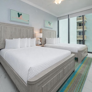 Experience comfort in this guest room with two queen beds, stylish decor, and coastal views