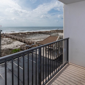 This balcony offers a stunning beachfront view, perfect for enjoying the serene coastal atmosphere