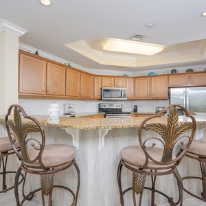Enjoy the inviting atmosphere of this modern kitchen with granite countertops and stylish bar seating for a cozy gathering