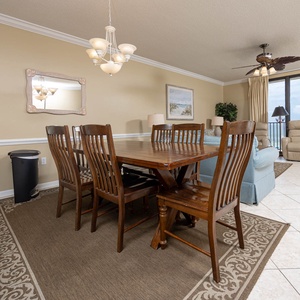 Gather around the wooden dining table, enjoying meals with a view of the coastline through large windows