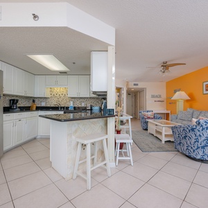 Savor morning coffee at the breakfast bar, enjoying the coastal vibe from your charming kitchen space