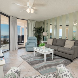 Relax in the inviting living area featuring a queen sleeper sofa, stylish decor, and beach balcony access